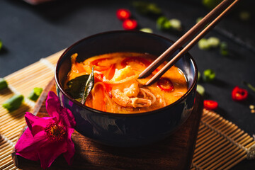 Coconut soup with shrimps and rice pasta. Hot bowl of exotic soup.