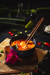 Coconut soup with shrimps and rice pasta. Hot bowl of exotic soup.