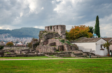 Fototapeta na wymiar View of the ruins of Its Kale, the Ottoman castle in Ioannina, Greece. The orthodox church of the Holy Unmercenaries (Agioi Anargyroi) is on the right while the modern city is on the left.