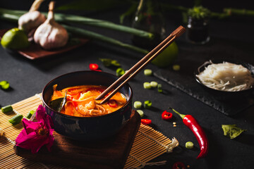 Coconut soup with shrimps and rice pasta. Hot bowl of exotic soup.