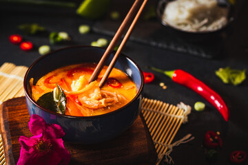 Coconut soup with shrimps and rice pasta. Hot bowl of exotic soup.