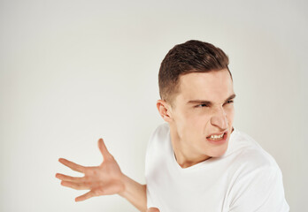 man in white t-shirt emotions angry look Studio