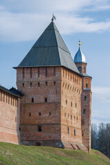 Obraz premium Pokrovskaya tower against the background of the Kokui tower on a April sunny day. Detinets of Veliky Novgorod, Russia