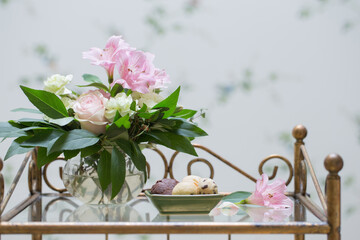 cookies and  bouquet in  glass vase in  vintage interior