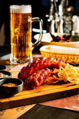 Grilled sausages with sauce and beer