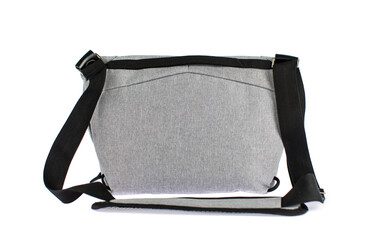 Isolated closeup studio shot of new small casual modern trendy fashionable fabric grey messenger rider men sling bag handbag baggage with strap and gray empty label tag in front of white background
