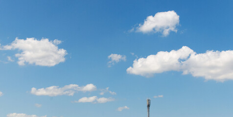 white clouds float across the blue sky