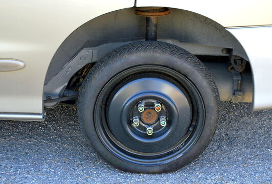 Space saver tire on a car.