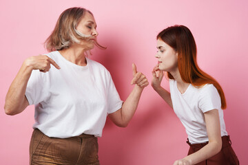 grandmother and granddaughter close communication together love pink background