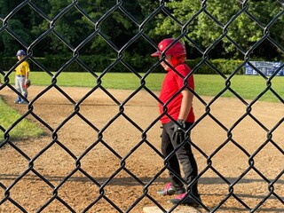 Baseball boy behind field