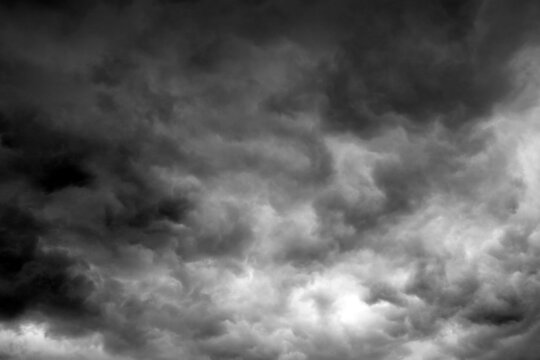blured background of storm clouds before heavy rain storm for background used , The sky is covered all  by black the clouds,