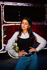 Night portrait of a brunette girl on the street