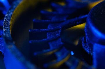 Blades of a computer cooler close-up in the dust. Blue lighting
