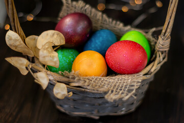 Fototapeta na wymiar Easter chicken painted eggs in a decorated wicker basket