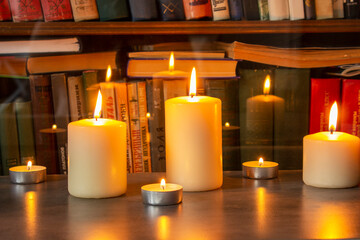 Beautiful hand made honey bee wax candles of different shapes lit by sunlight