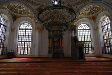 Inside the old ottoman Mosque (Cami) in Konya Turkey. Facade and imam reading the quran with mosques huge windows and light coming inside. 24.07.2021. Konya. Turkey