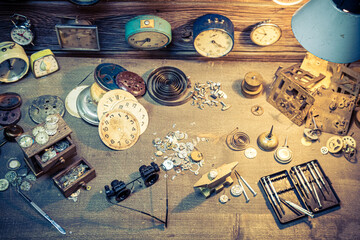 Aged watchmaker's workshop with repaired clocks. Ancient watchmaker's workshop.