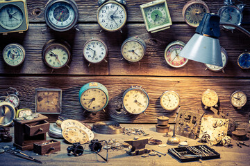 Forgotten watchmaker's workplace. Watchmaker's workplace with ruined clocks.
