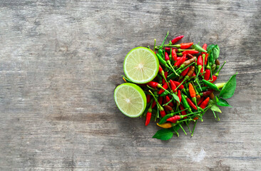 Fresh chili with fresh lemon. On wooden floor, top view, copy space