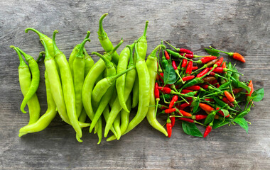 Banana Pepper and hot chilli  isolated against a wood background