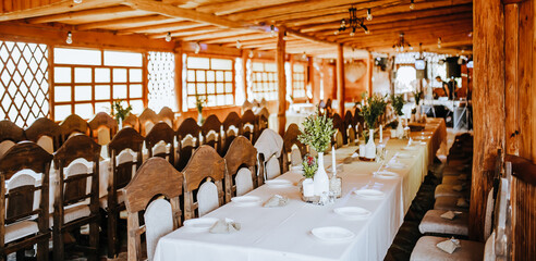 Wedding banquet decoration. Place for the guests decorated with flowers and plants at the party