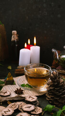 Wooden runes are lying on the table among the papers with notes. There is a mug of tea next to it. Astrology and esotericism. Esoteric breakfast.