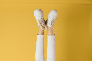 Fototapeta premium womens inverted legs upside down white sneakers fashion