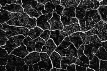 abstract black background with white cracks overlay ground cracked drought, old paint