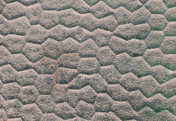 Texture of a brick wall with a hexagonal pattern - background of a wall with a turtle shell pattern