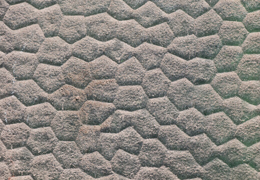 Texture of a brick wall with a hexagonal pattern - background of a wall with a turtle shell pattern