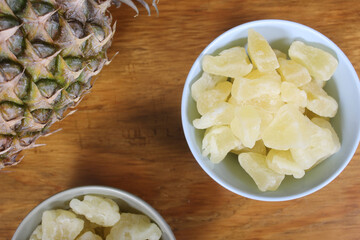 Fresh Pineapple With Dried Pineapple on Wooden Table