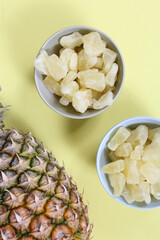 Fresh and Dried Pineapple on yellow Background Closeup