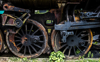 old steam locomotive wheels covered in rust