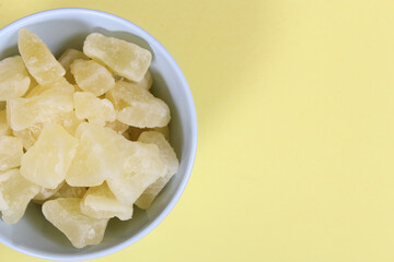 Fresh and Dried Pineapple on yellow Background Closeup