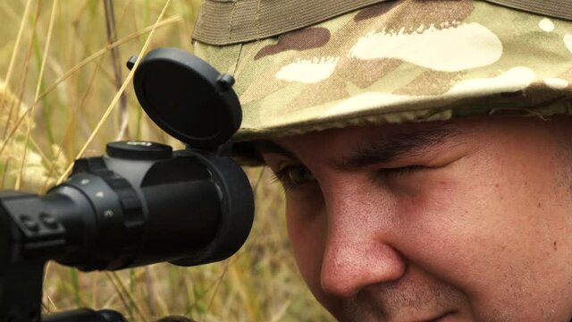 sniper looking through the scope close-up