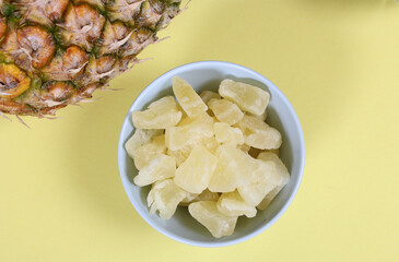 Fresh and Dried Pineapple on yellow Background Closeup