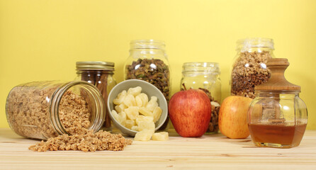 Honey With Granola, Dried Pineapple and Apples in Rustic Kitchen