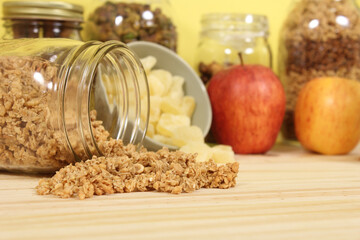 Honey With Granola, Dried Pineapple and Apples in Rustic Kitchen