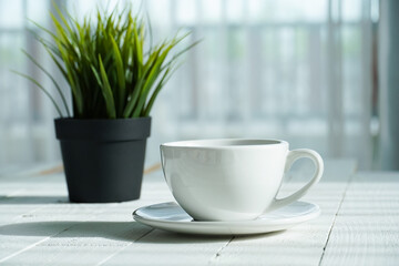 cup of coffee and pot on wood table