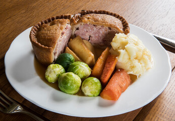plate of vegetables including carrots and sprouts with pork pie and gravy