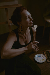 Girl painterin in a dark room