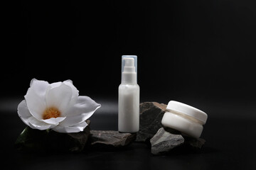The composition of bottles of cosmetics for face care. A tube of gel, a jar of cream, empty packages without a brand. Advertising of skin care products