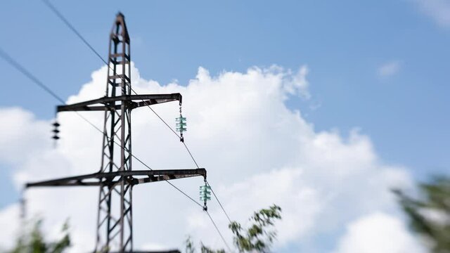 Timelapse of clouds near the power line. Taken on the "lens baby" with the effect titl shift