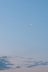 evening clear sky with a moon and clouds below