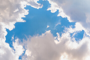 large volumetric light-transmitting clouds with gaps in the blue sky