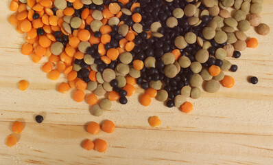 Fototapeta na wymiar Dried Black, Green and Orange Lentils on Wooden Table