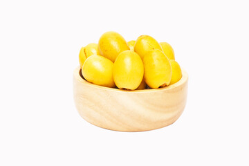 Fresh date fruit yellow gold undried on cup wood (Phoenix dactylifera L. sylvestris) The taste is sweet, crispy, delicious. is becoming popular. Isolated on white background.