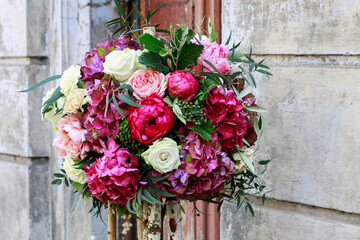 Wedding floral decoration with roses, peonies, hortensias, carnations and other flowers.