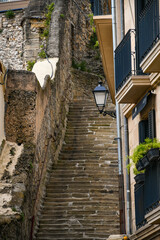 Fototapeta na wymiar Street with steps in the historic center of San Sebastián (Donostia), Guipuzcoa, Country Basque, Spain.