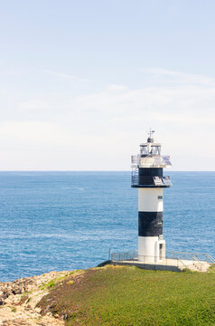 Nice view of the lighthouse of the town of Ribadeo during the day, as one of the most touristic natural environments of Gallicia, vertical shot.